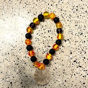 Im selling a bracelet for a pretty low price it has black yellow and gold beeds.